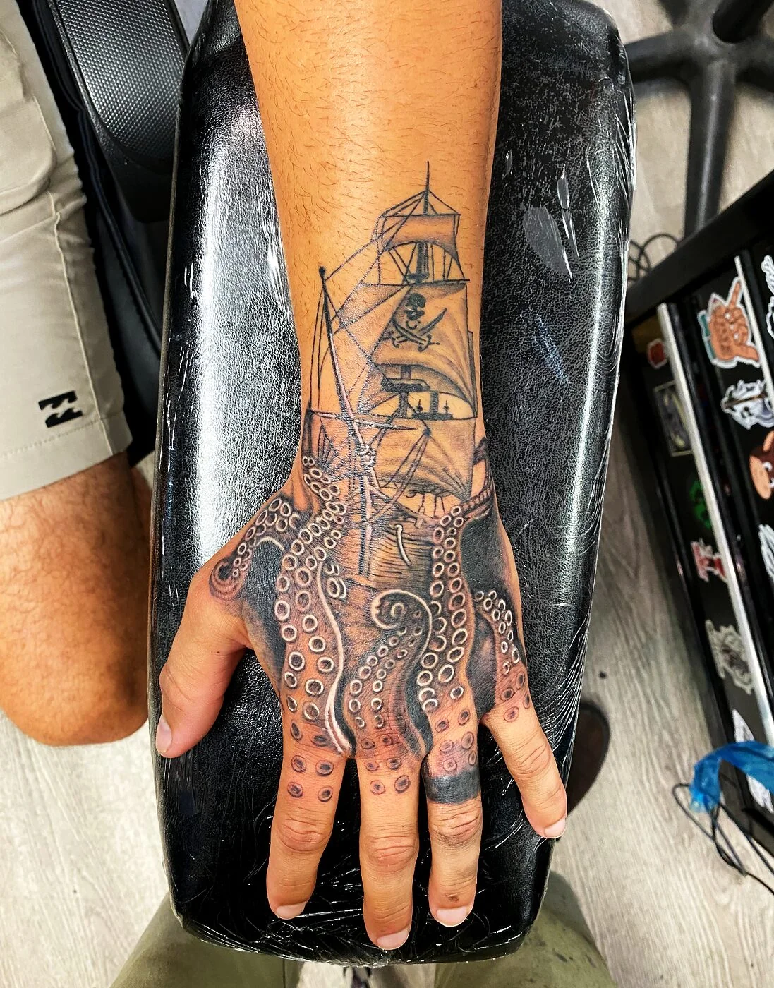 Black & Grey pirate ship with octopus tentacles tattoo on hand by 2bit (Chris Curren) at Lost at Sea Tattoo, Chinatown, Honolulu