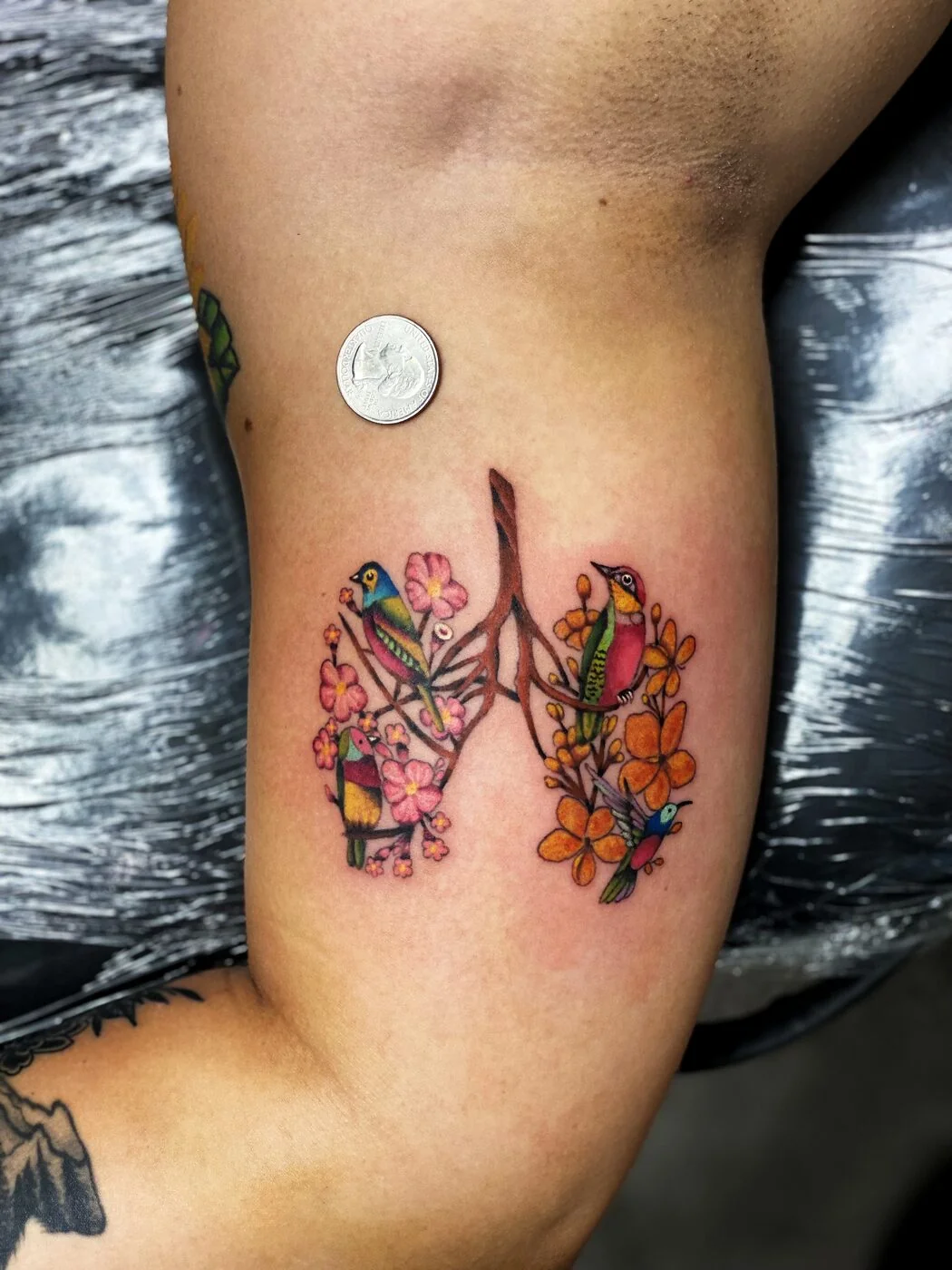 Color Realism colorful birds and flowers shaped like lungs tattoo on ribs by 2bit (Chris Curren) at Lost at Sea Tattoo, Chinatown, Honolulu