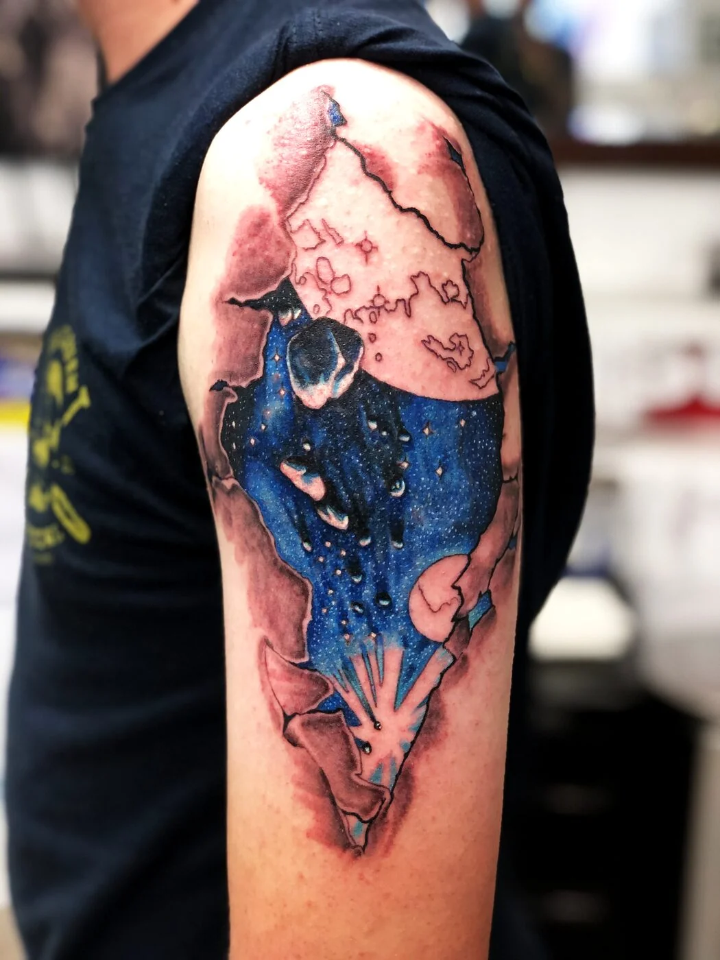 Color Realism galaxy night sky bursting through torn skin tattoo on shoulder by 2bit (Chris Curren) at Lost at Sea Tattoo, Chinatown, Honolulu