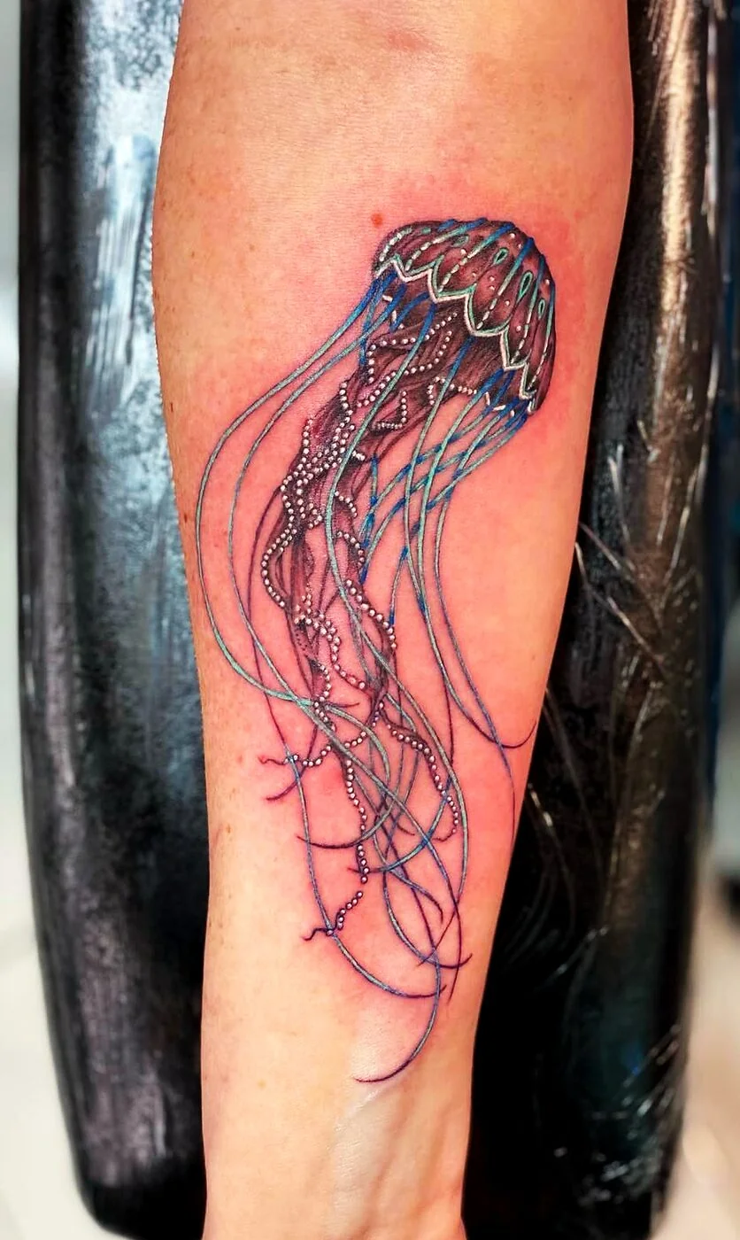 Color Realism detailed jellyfish with long tentacles tattoo on forearm by 2bit (Chris Curren) at Lost at Sea Tattoo, Chinatown, Honolulu