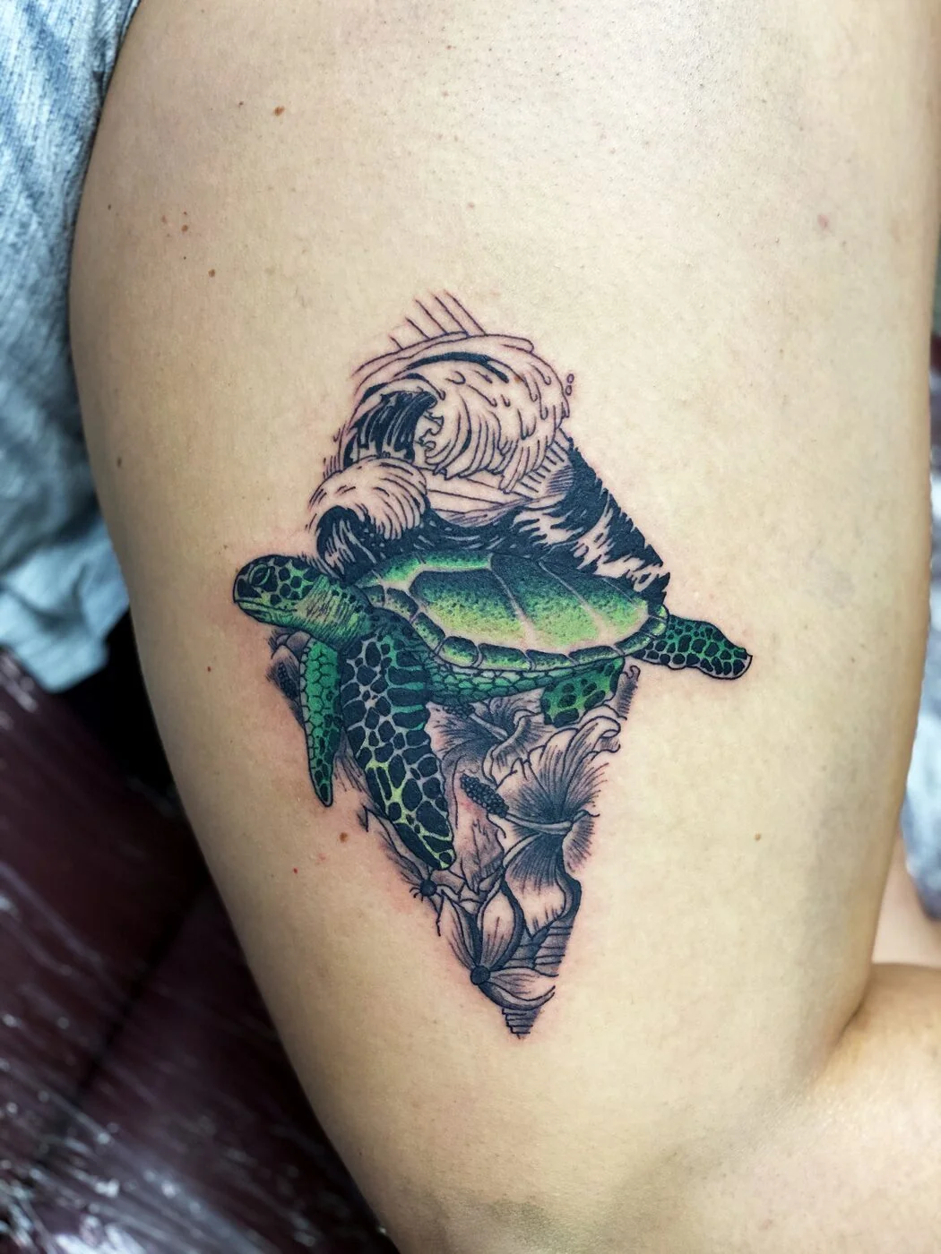 Color Realism sea turtle with wave and hibiscus tattoo on thigh by 2bit (Chris Curren) at Lost at Sea Tattoo, Chinatown, Honolulu