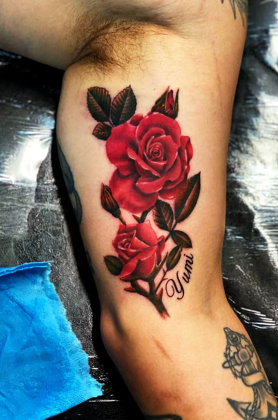 Color Realism red roses with Yumi script tattoo on bicep by 2bit (Chris Curren) at Lost at Sea Tattoo, Chinatown, Honolulu