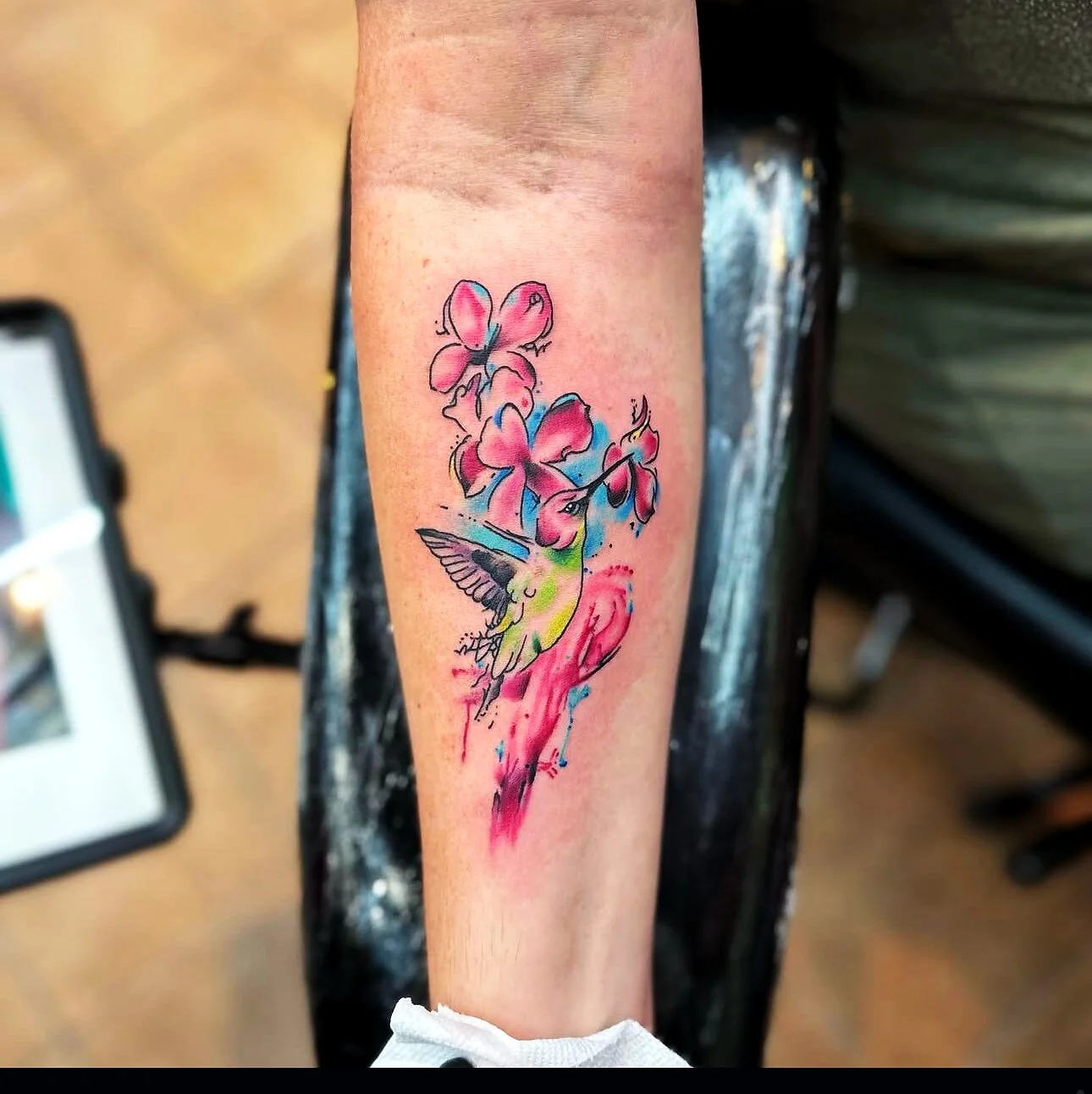 Illustrative watercolor hummingbird with hibiscus tattoo on forearm by 2bit (Chris Curren) at Lost at Sea Tattoo, Chinatown, Honolulu