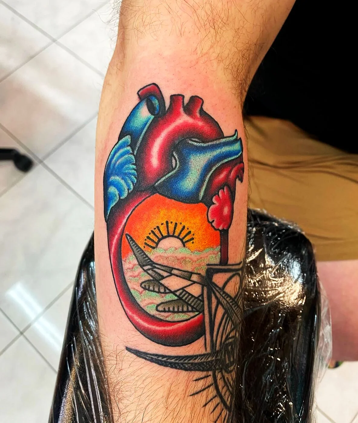 Neo-Traditional anatomical heart with sunset and palm tree inside tattoo on forearm by 2bit (Chris Curren) at Lost at Sea Tattoo, Chinatown, Honolulu